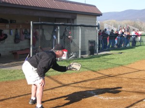 Coach Hunt filling in while the catcher gets ready