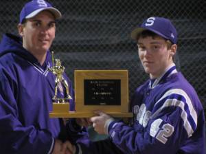 Strasburg AD Matt Hiserman presents the trophy to one of his own